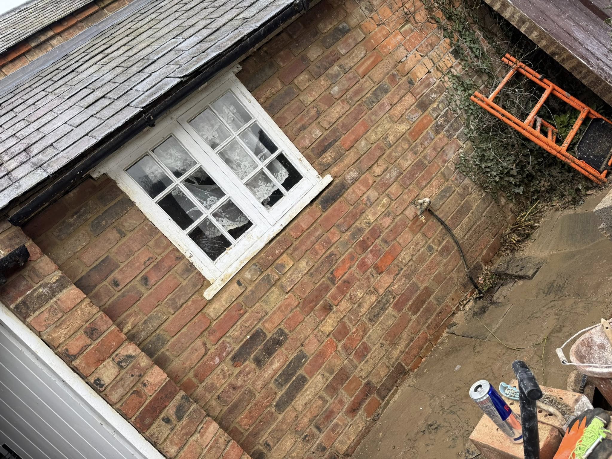 Brick extension with sash window, viewed from above